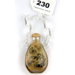 An unusual Chinese inside painted glass snuff bottle signed and with integral "chain" carrying loop,