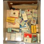 A box of cigarette packets containing cigarette cards.