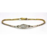 An 18ct yellow gold and platinum (stamped 18ct) diamond set bracelet, L. 17cm.