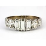 A white metal (tested 18ct gold) ring set with baguette and brilliant cut diamonds, approx. 2.15ct