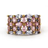 A 9ct yellow gold ring set with pink sapphires and other semi precious stones, (N.5).