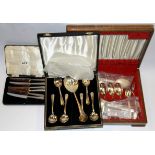 A case of silver handled butter knives with a cased silverplated cutlery set and fruit set.