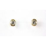 A pair of yellow metal (tested 18ct gold) diamond set stud earrings, approx. 0.50ct overall.