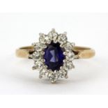 A 9ct yellow gold spinel set cluster ring, (M.5).