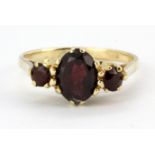 A 9ct yellow gold garnet set ring, (N).