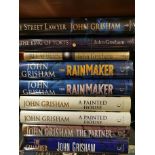 Nine books by John Grisham including some duplicates and first editions.