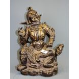 An unusual Chinese painted and gilt cast iron figure of a guardian deity, H. 37cm.