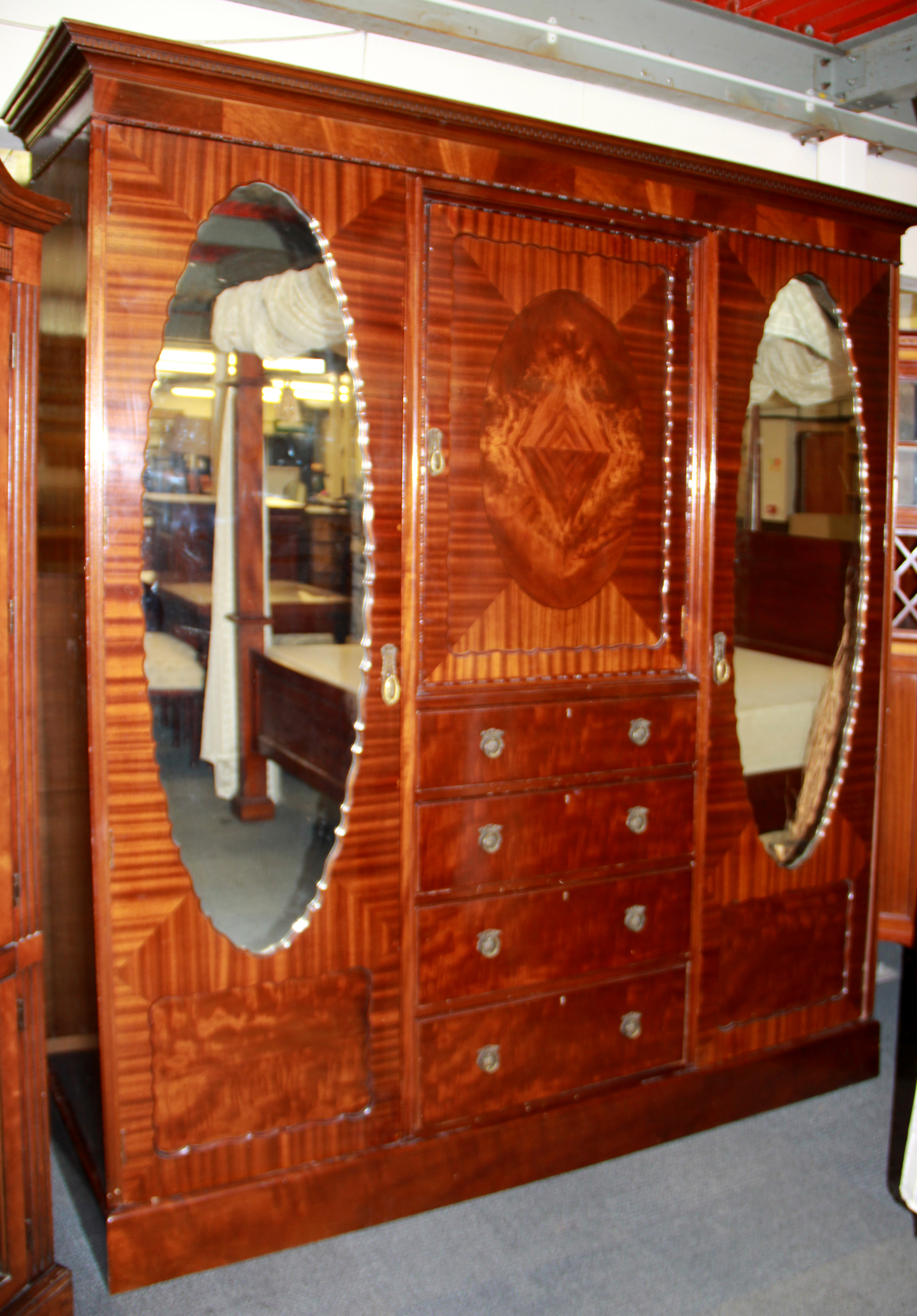 A 1920's mahogany triple wardrobe, W. 189cm H. 210cm.