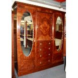 A 1920's mahogany triple wardrobe, W. 189cm H. 210cm.