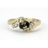 A 9ct yellow gold crossover ring set with sapphires and diamonds, (I.5).