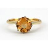 A 9ct yellow gold solitaire ring set with a round cut orange topaz, (M.5).
