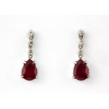 A pair of 900 platinum drop earrings set with pear cut rubies and brilliant cut diamonds, L. 1.6cm.