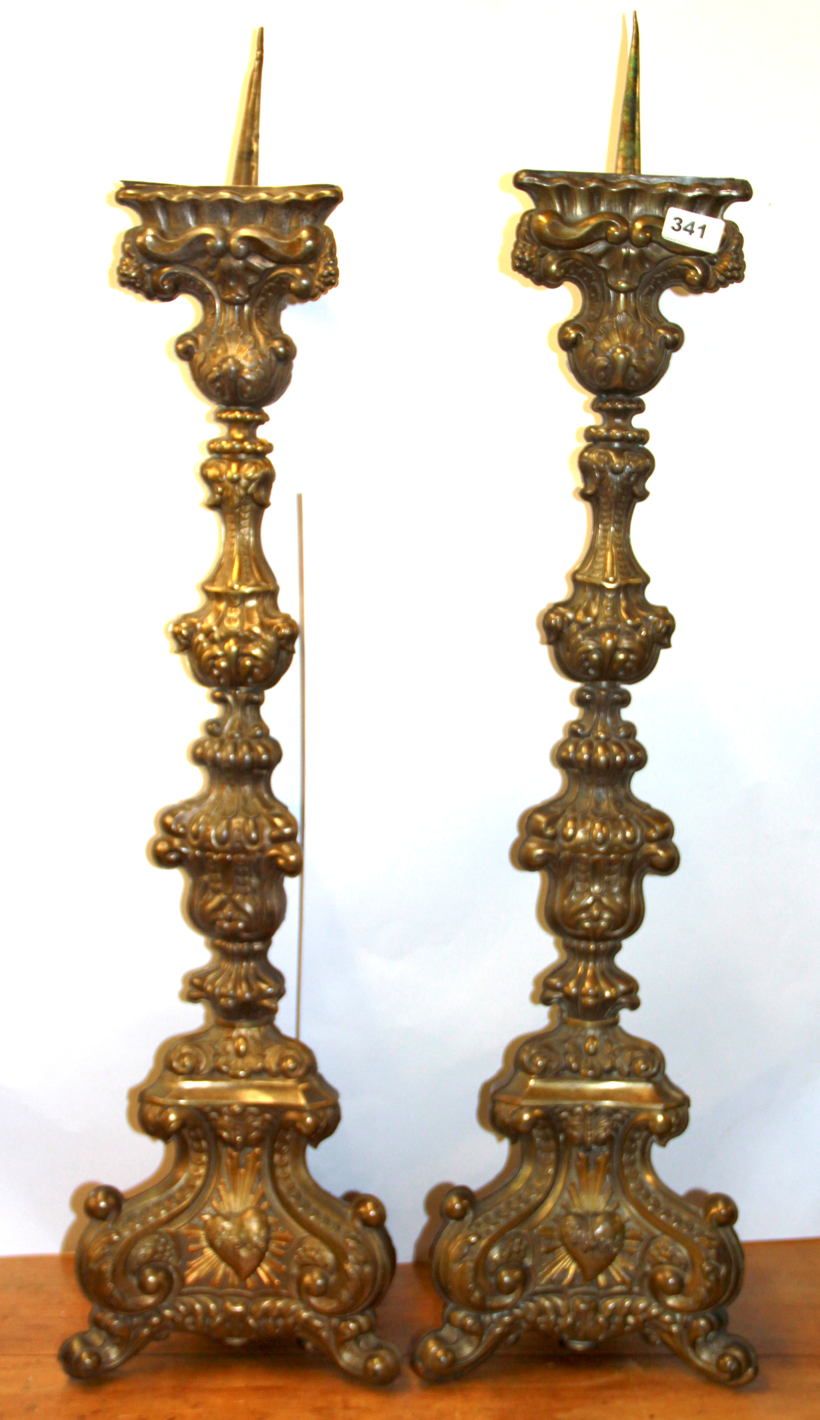 A pair of large Continental stamped brass church candlesticks, H. 94cm.