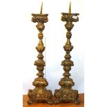 A pair of large Continental stamped brass church candlesticks, H. 94cm.