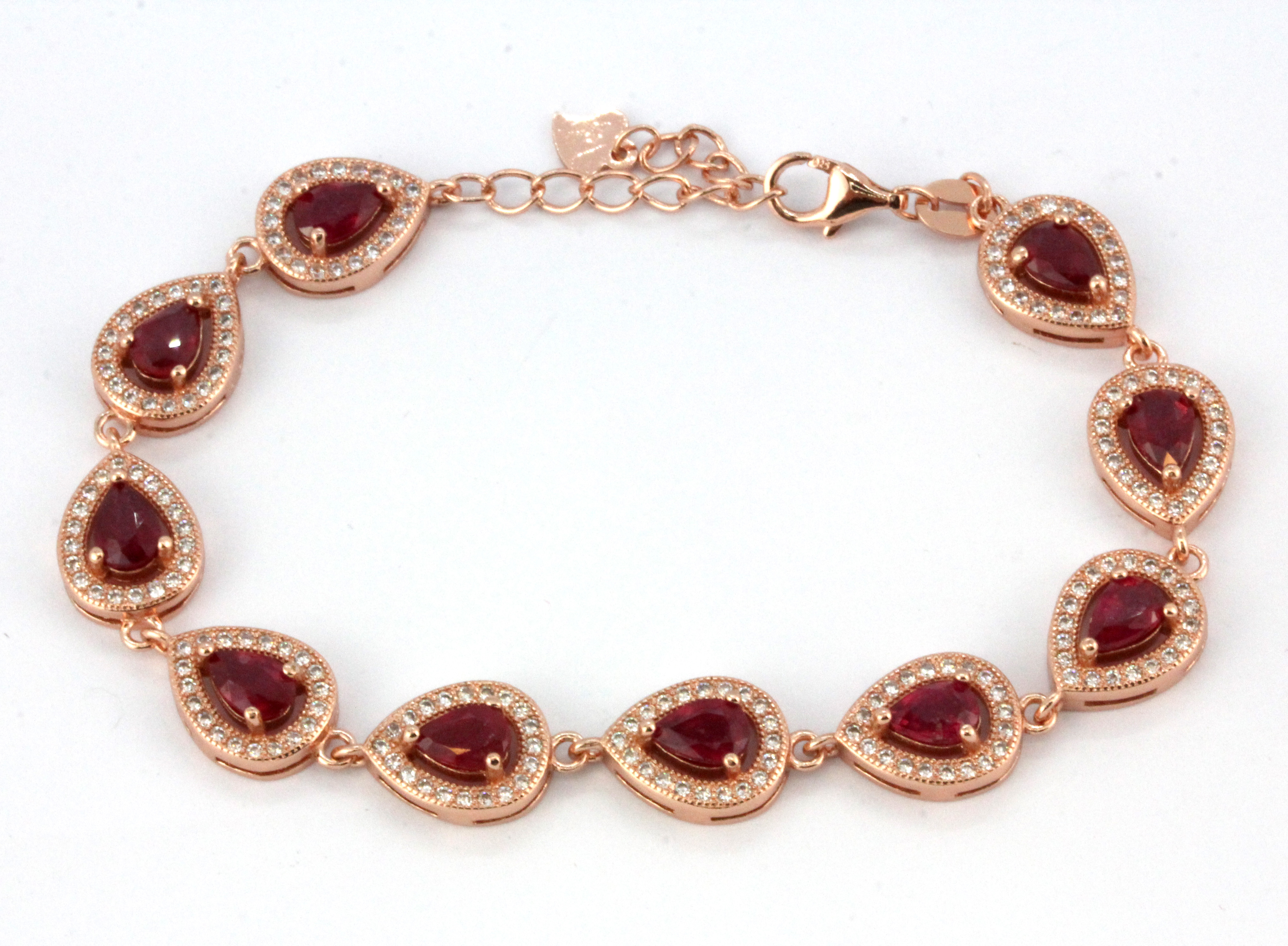 A 925 rose gold gilt pear cut ruby and white stone set bracelet, L. 20cm.