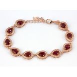 A 925 rose gold gilt pear cut ruby and white stone set bracelet, L. 20cm.