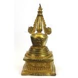 A Tibetan gilt bronze stupa, H. 28cm.