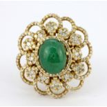 An 18ct yellow gold (worn stamp 18k) ring set with a cabochon cut jade and diamonds, 3.5 x 3cm, (