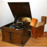 An HMW model 109 oak cased portable grammophone and a case of 78 RPM records.