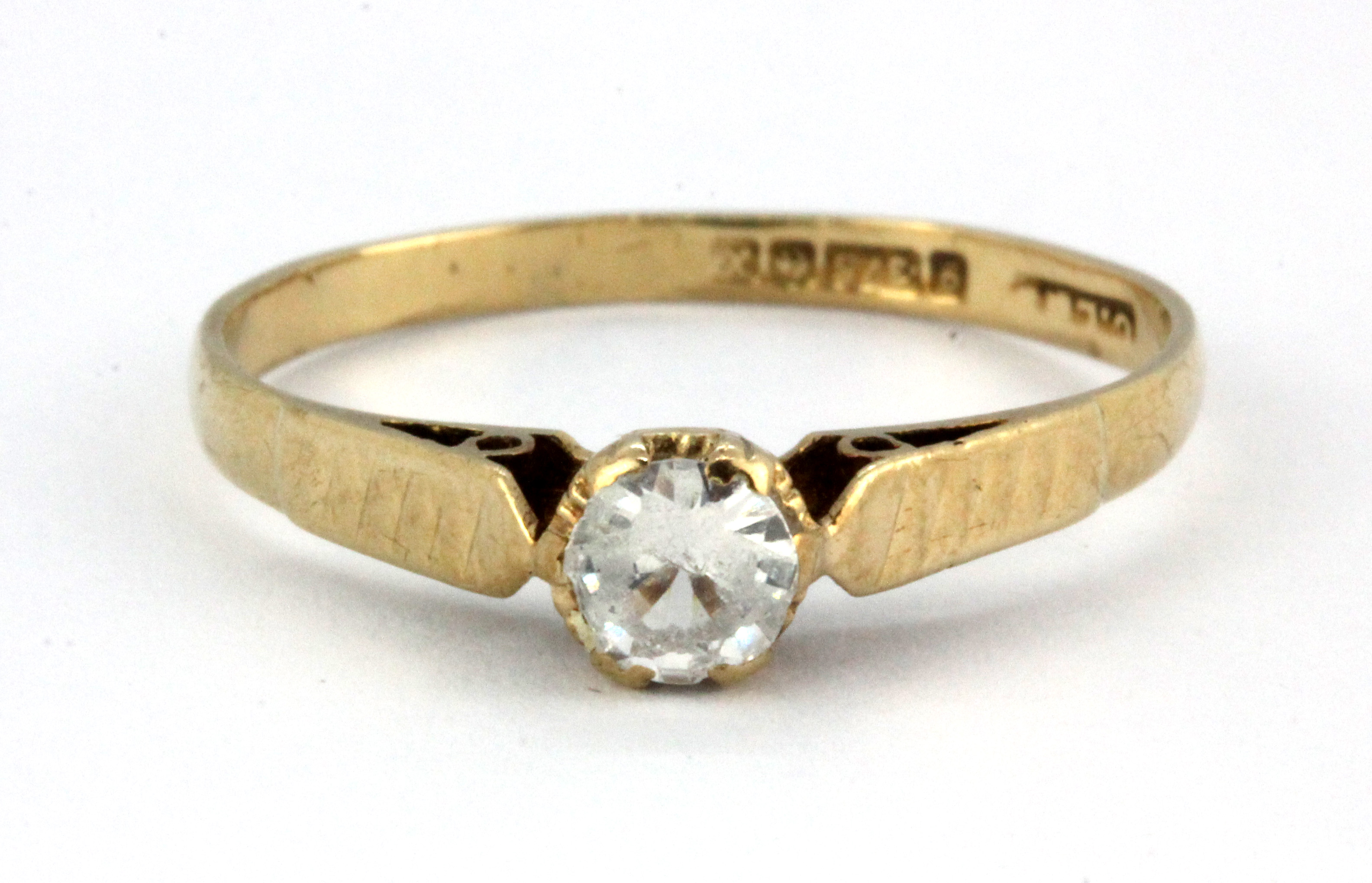 A 9ct yellow gold stone set solitaire ring, (M).