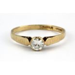 A 9ct yellow gold stone set solitaire ring, (M).