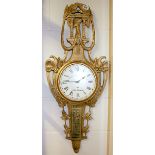 An ornate wooden wall clock, H. 100cm understood to be in working order.