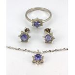 A matching suite of 925 silver ring, pendant and earrings set with cabochon cut tanzanite and