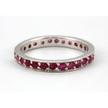 A 925 silver ruby set full eternity ring (O).