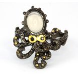 A Hana Maae designer 925 silver gilt octopus shaped ring set with opal and sapphire set eyes, (Q).