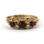 A 9ct yellow gold garnet and white stone set ring, (R.5) (one stone missing).