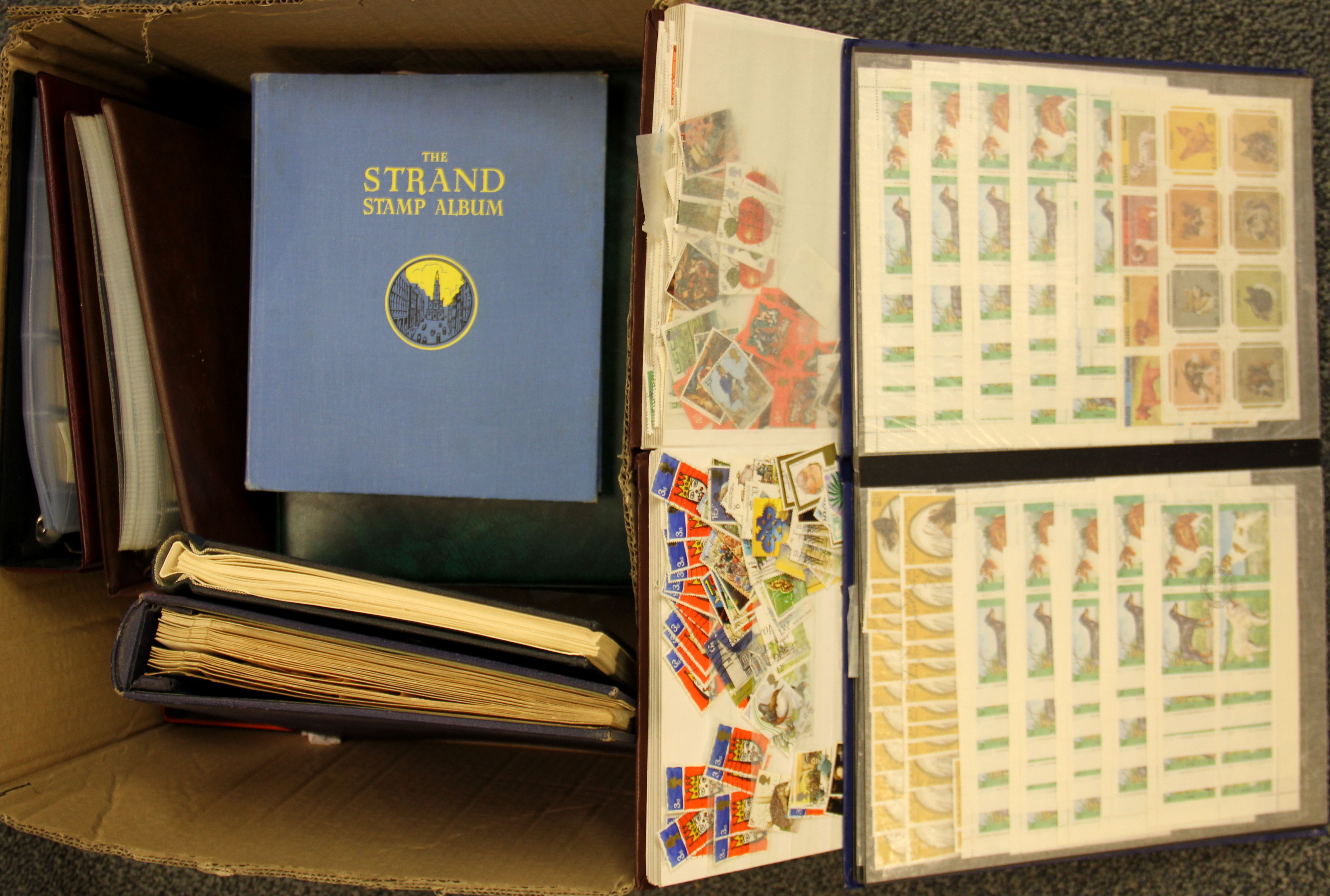 A box of mixed stamp albums.