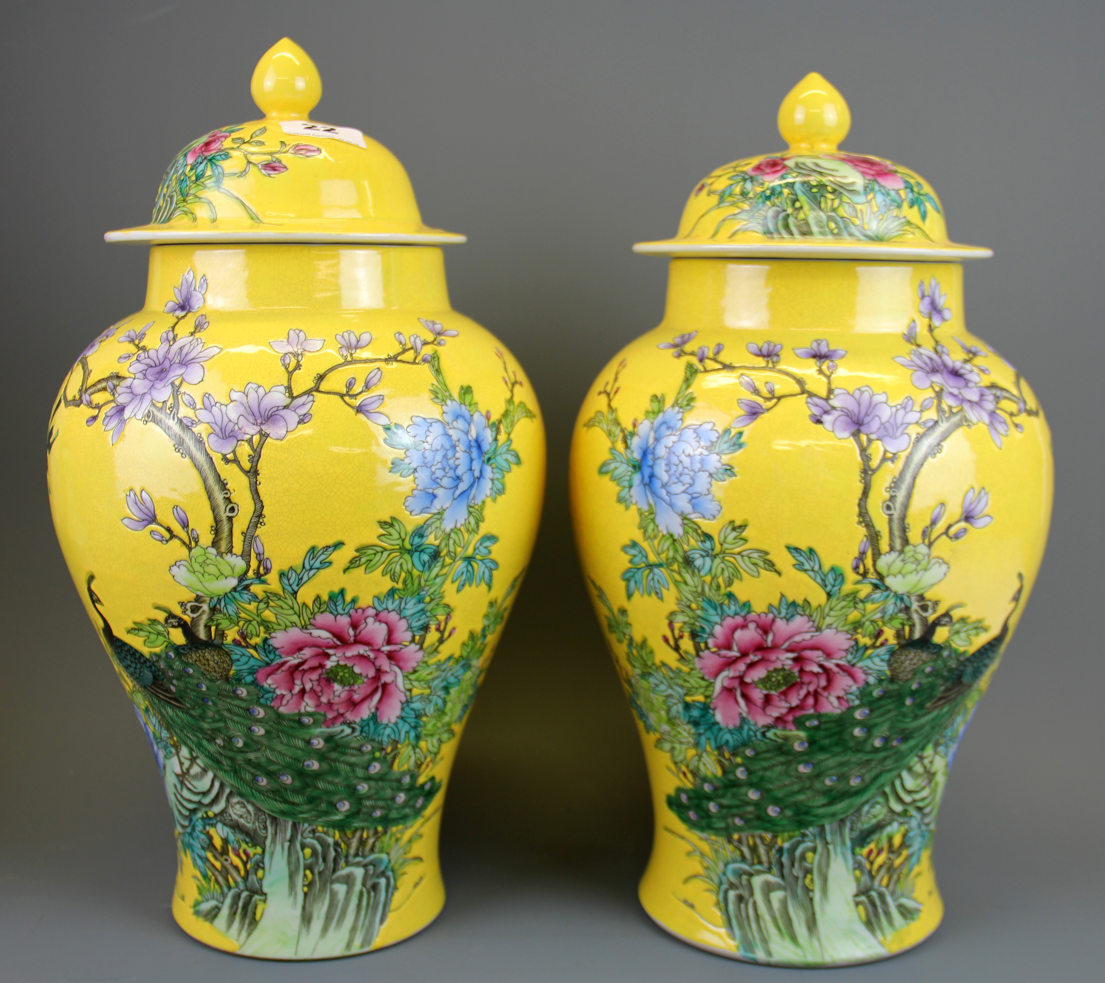 A pair of Chinese mid 20th Century hand enamelled jars and lids decorated with birds and flowers, H.