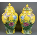 A pair of Chinese mid 20th Century hand enamelled jars and lids decorated with birds and flowers, H.