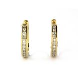 A pair of 9ct yellow gold diamond channel set hoop earrings, L. 1.5cm.