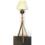 A Victorian wrought iron oil lamp stand converted to an electric standard lamp, H. 151cm.