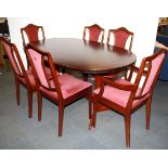 A 1970's extending mahogany dining table and six chairs, size closed 99 x 159cm.