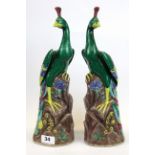 A pair of Chinese hand painted porcelain figures of peacocks, H. 35cm.