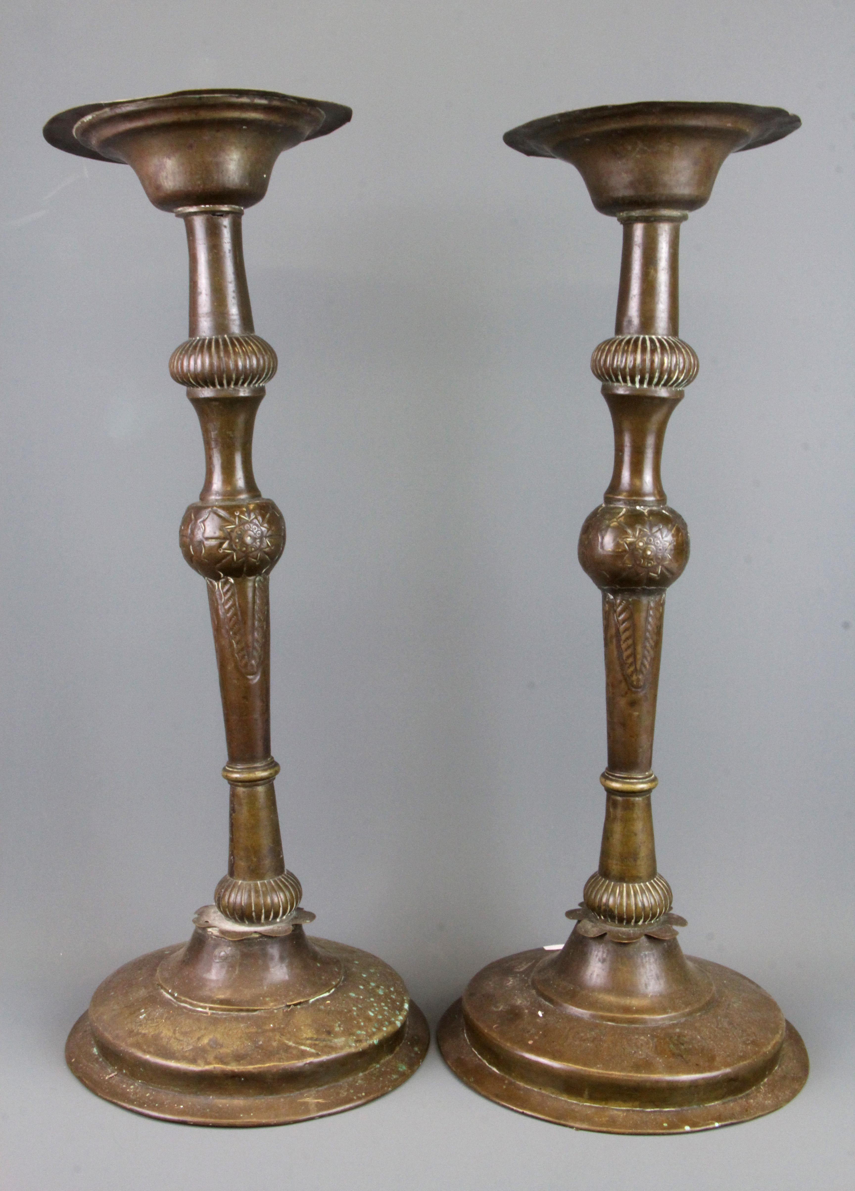 A pair of 19th Century hammered Eastern brass candlesticks, H. 48cm.