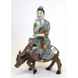 A 19th/ early 20th Century Chinese porcelain figure of a female deity riding a water buffalo, H.