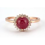 A 925 silver rose gold gilt ring set with a cabochon cut ruby and white stones, (O).