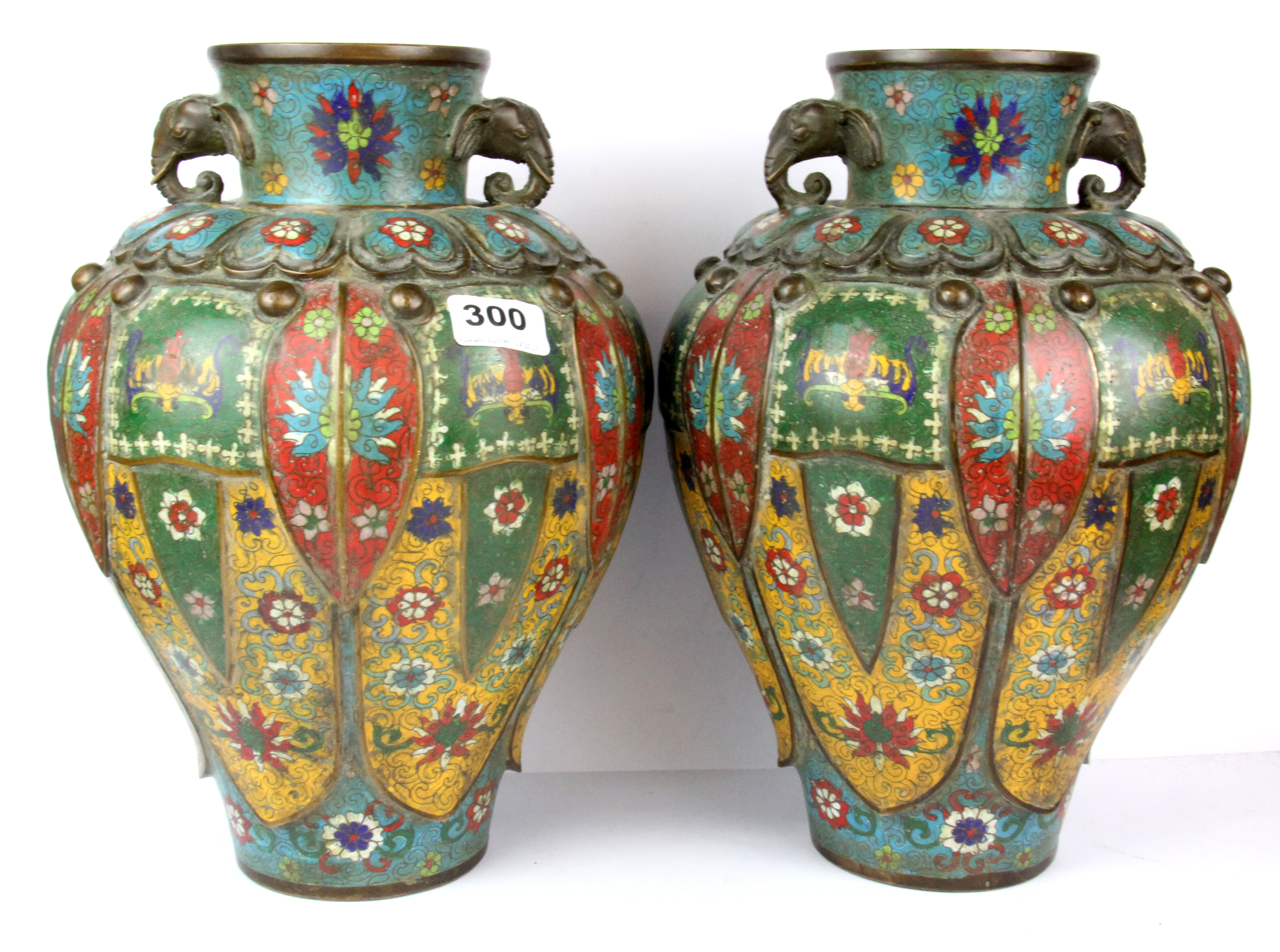 A superb pair of Chinese cloisonne on bronze lobed vases with elephant head handles, H. 33cm.