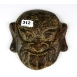 An interesting Chinese archaic form carved brown jade mask of a fearsome guardian, size 19 x 19 x