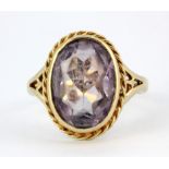 A 9ct yellow gold ring set with an oval cut amethyst, (N.5).
