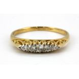 An 18ct yellow gold (work stamp) ring set with five graduated old cut diamonds, (R).
