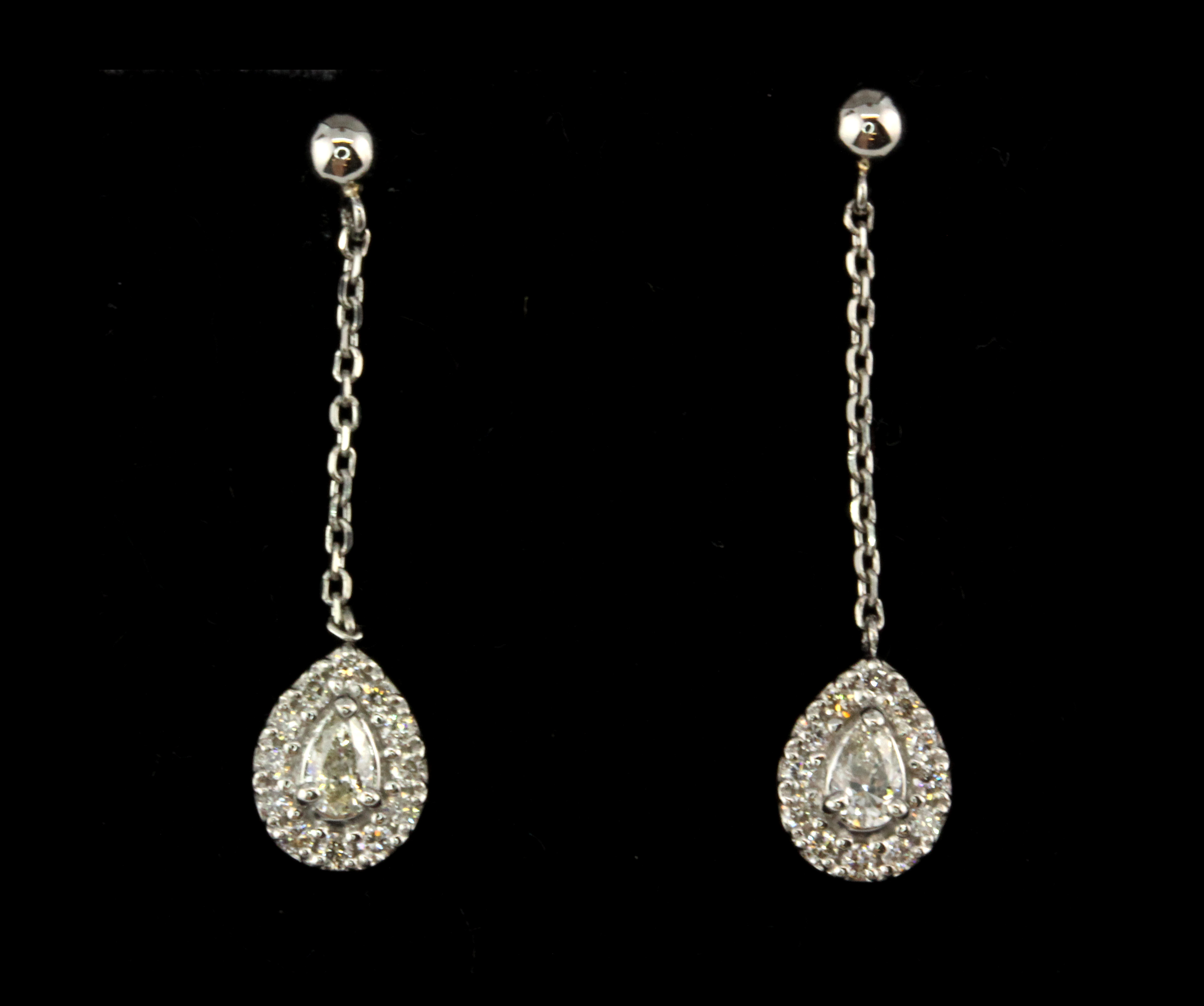 A pair of 900 platinum drop earrings set with pear and brilliant cut diamonds, L. 2.2cm.