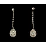 A pair of 900 platinum drop earrings set with pear and brilliant cut diamonds, L. 2.2cm.