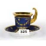 A 19th century French Empire porcelain cup and saucer, saucer Dia. 15cm, overall H. 11.5cm.