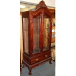 A contemporary carved hardwood display cabinet, W. 92cm H. 205cm.