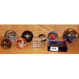 A group of mixed glass paperweights.
