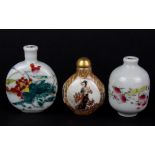 A group of three Chinese porcelain snuff bottles, tallest H. 7cm.